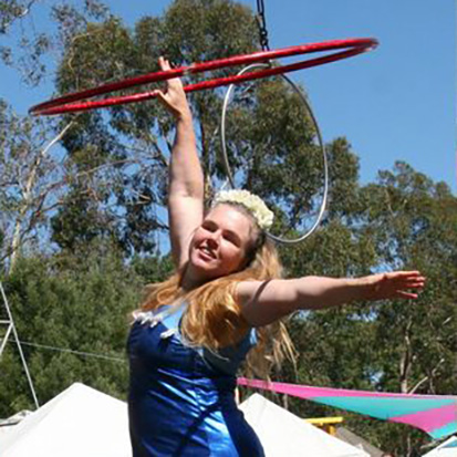 Adult woman hula hooping outdoors
